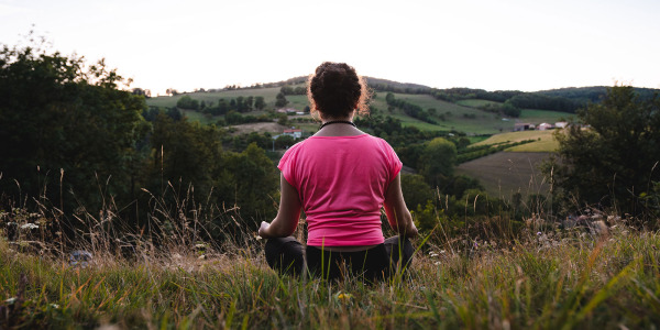 woman meditating on nice panoramic view