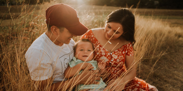 family with small child in grain field