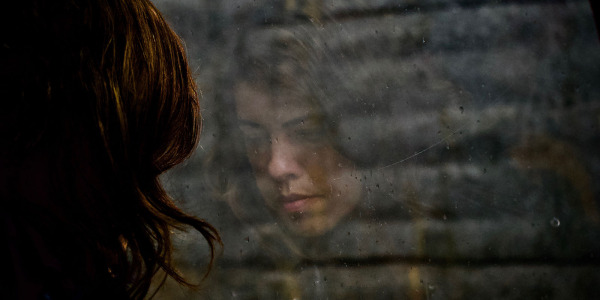 a reflection of a women through the window
